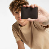 Status Anxiety Otis Wallet in chocolate color, featuring multiple card slots and a sleek leather design.