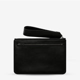 Black Status Anxiety Take Your Chances wallet with smooth leather finish, featuring multiple card slots and a sleek, minimalist design.
