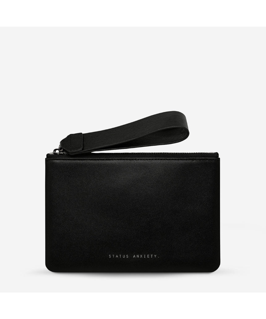 Black Status Anxiety Take Your Chances wallet with smooth leather finish, featuring multiple card slots and a sleek design.