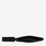 Open black Status Anxiety Take Your Chances wallet with multiple card slots and a smooth leather finish.