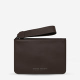 Status Anxiety Take Your Chances wallet in cocoa leather showing smooth front with subtle branding and compact design.