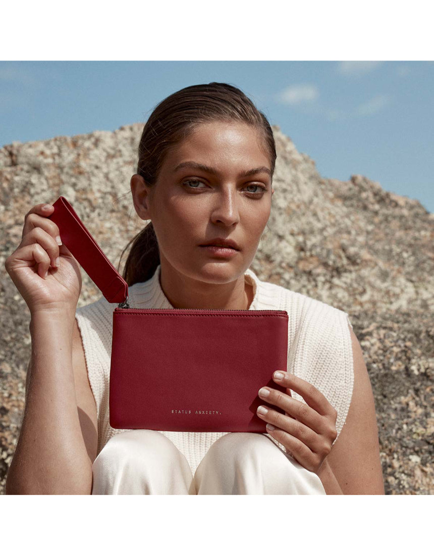 Status Anxiety Take Your Chances Wallet in rouge red, featuring a sleek leather design and multiple card slots.