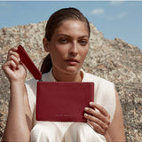 Status Anxiety Take Your Chances Wallet in rouge red, featuring a sleek leather design and multiple card slots.