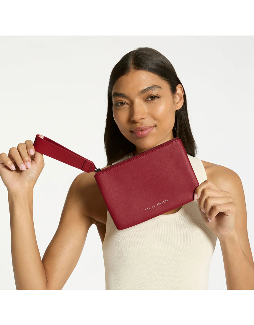 Status Anxiety Take Your Chances Wallet in rouge, featuring a compact leather design with multiple card slots and a sleek finish.