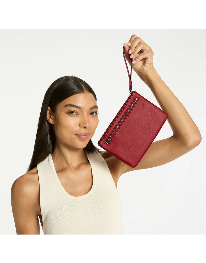 Status Anxiety Take Your Chances wallet in rouge color, featuring a sleek leather design with multiple card slots and a minimalist style.