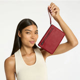 Status Anxiety Take Your Chances wallet in rouge color, featuring a sleek leather design with multiple card slots and a minimalist style.