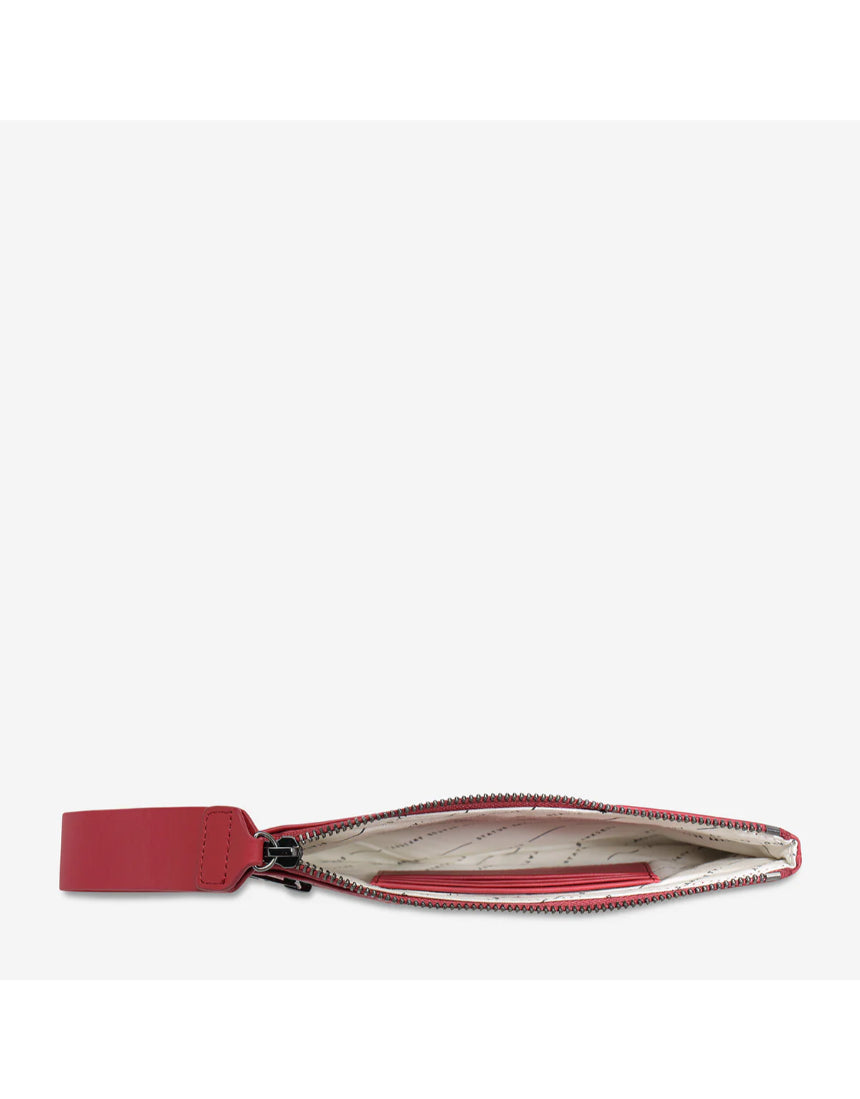 Open Status Anxiety Take Your Chances wallet in rouge smooth leather showing card slots and interior compartments.