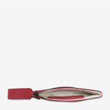 Open Status Anxiety Take Your Chances wallet in rouge smooth leather showing card slots and interior compartments.
