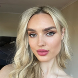 Suzy Lipsticks Miss Cassandra Peony matte lipstick tube with the lipstick partially extended, showcasing soft pink shade.