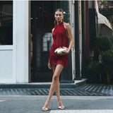 Olga Berg Tally Metallic Clutch in gold with a sleek, shiny finish and compact design for elegant evening occasions.