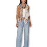 Model wearing The Artists Label Julie’s Garden scarf featuring floral patterns and vibrant colors.