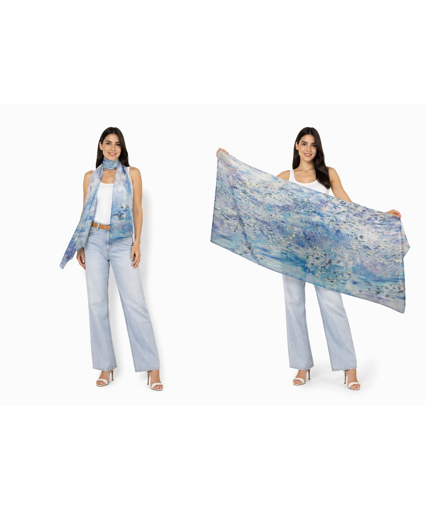 The Artists Label viscose modal scarf featuring a "Swept Beneath the Sea" design with ocean-inspired patterns in blue and white.