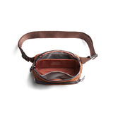 Bellroy Venture Hip Pack in bronze with multiple compartments, adjustable strap, and sleek design for convenient carrying.