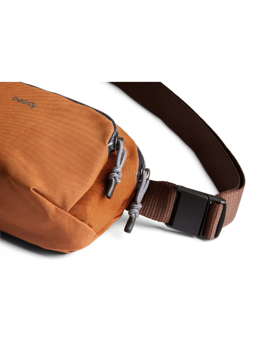 Bellroy Venture Hip Pack in bronze, showcasing its compact design and adjustable strap for easy carry and storage.