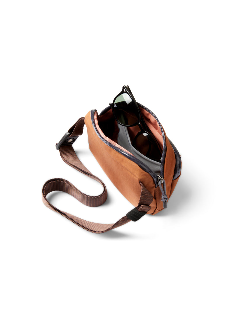 Bellroy Venture Hip Pack in bronze with multiple compartments and adjustable strap, designed for convenient everyday carry.