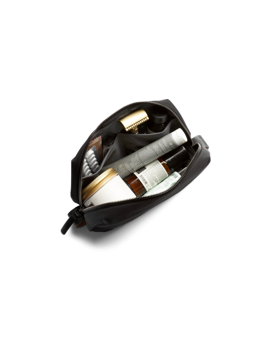 Bellroy black toiletry kit with zipper closure and multiple compartments for organizing grooming essentials.