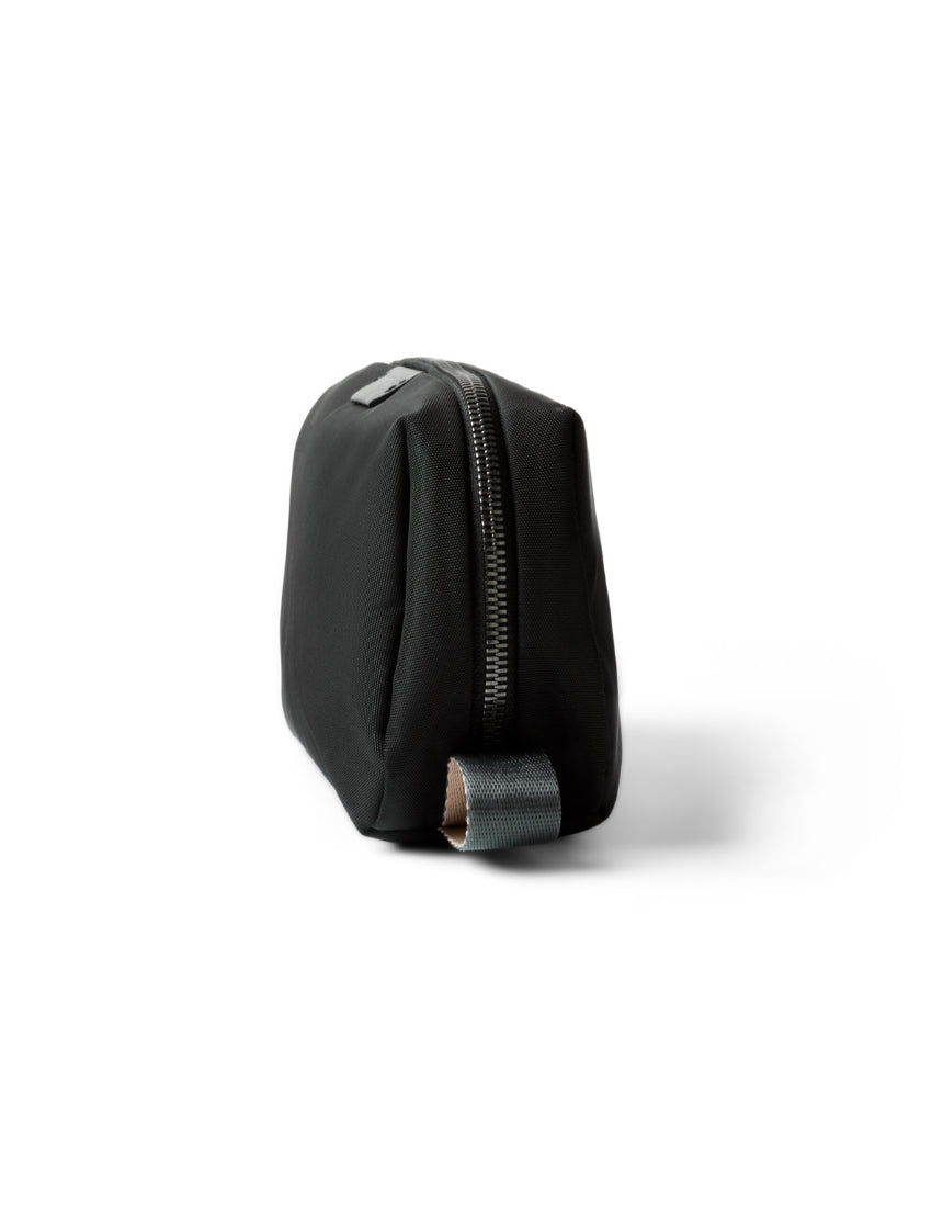 Bellroy black toiletry kit with zipper closure and multiple compartments for organizing personal grooming essentials.