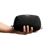 Bellroy black toiletry kit with zipped compartments and compact design, ideal for travel storage of grooming essentials.