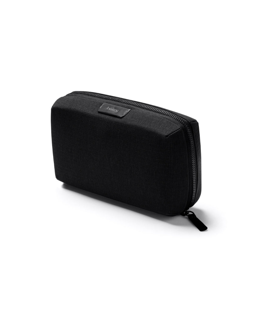 Bellroy Tech Kit in black with multiple compartments for organizing cables, chargers, and tech accessories.
