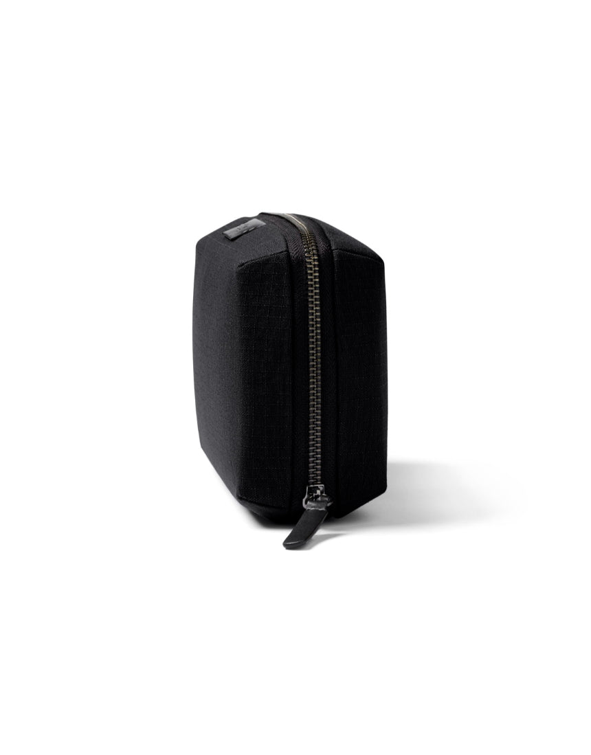 Bellroy Tech Kit in black showing compact design with multiple compartments for organizing cables and accessories.