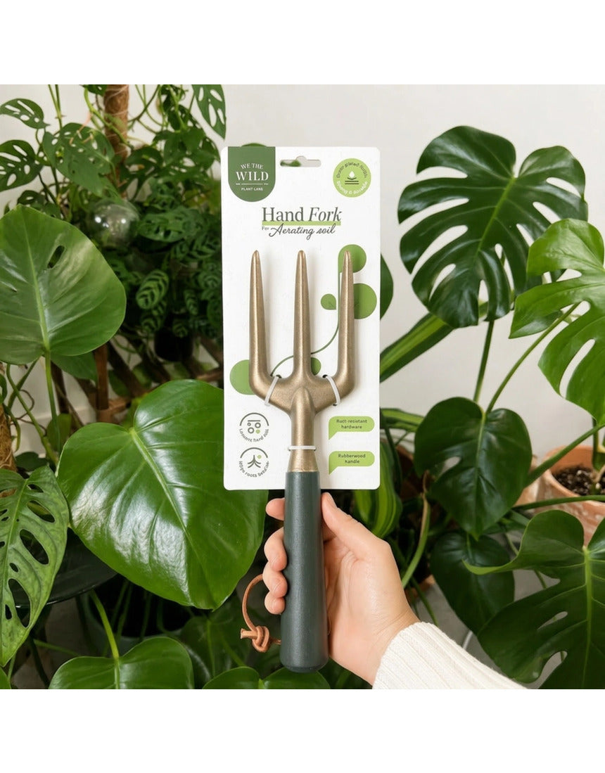 Green We The Wild hand fork garden tool with ergonomic handle, ideal for planting and cultivating in the garden.