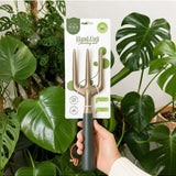 Green We The Wild hand fork garden tool with ergonomic handle, ideal for planting and cultivating in the garden.