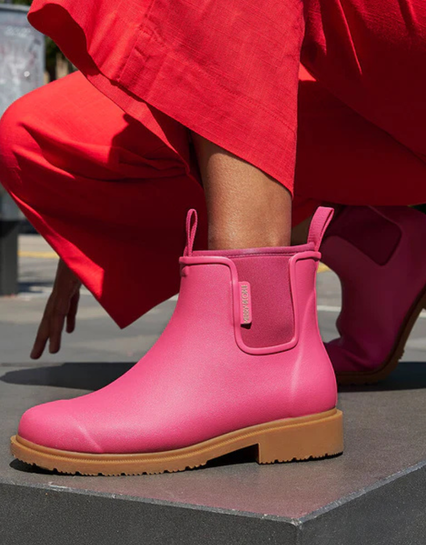 Fuchsia pink Merry People Bobbi gumboots with waterproof design and rubber soles, suitable for rainy weather.
