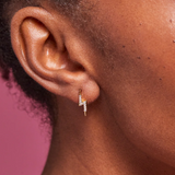 Estella Bartlett lightning bolt earrings with gold-tone finish, featuring sleek, modern lightning bolt design on shiny metal studs.