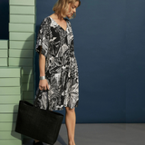 Elk Lento dress in soft fabric, featuring a relaxed fit and stylish design, modeled on a person wearing it outdoors.