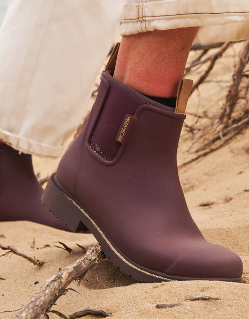 Dark cherry Merry People Bobbi gumboots with black soles and shiny finish, stylish waterproof footwear for rainy days.