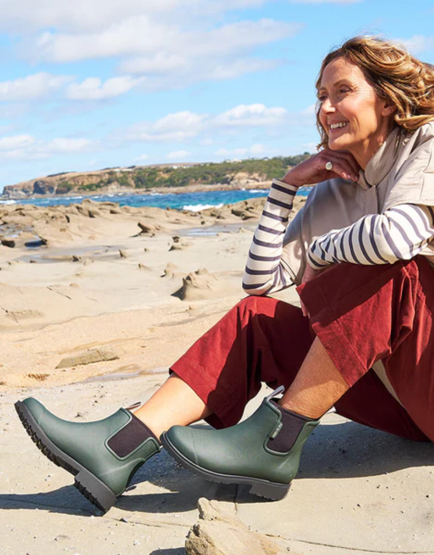Forest green Merry People Bobbi gumboots with black soles, waterproof rubber footwear for rainy weather.