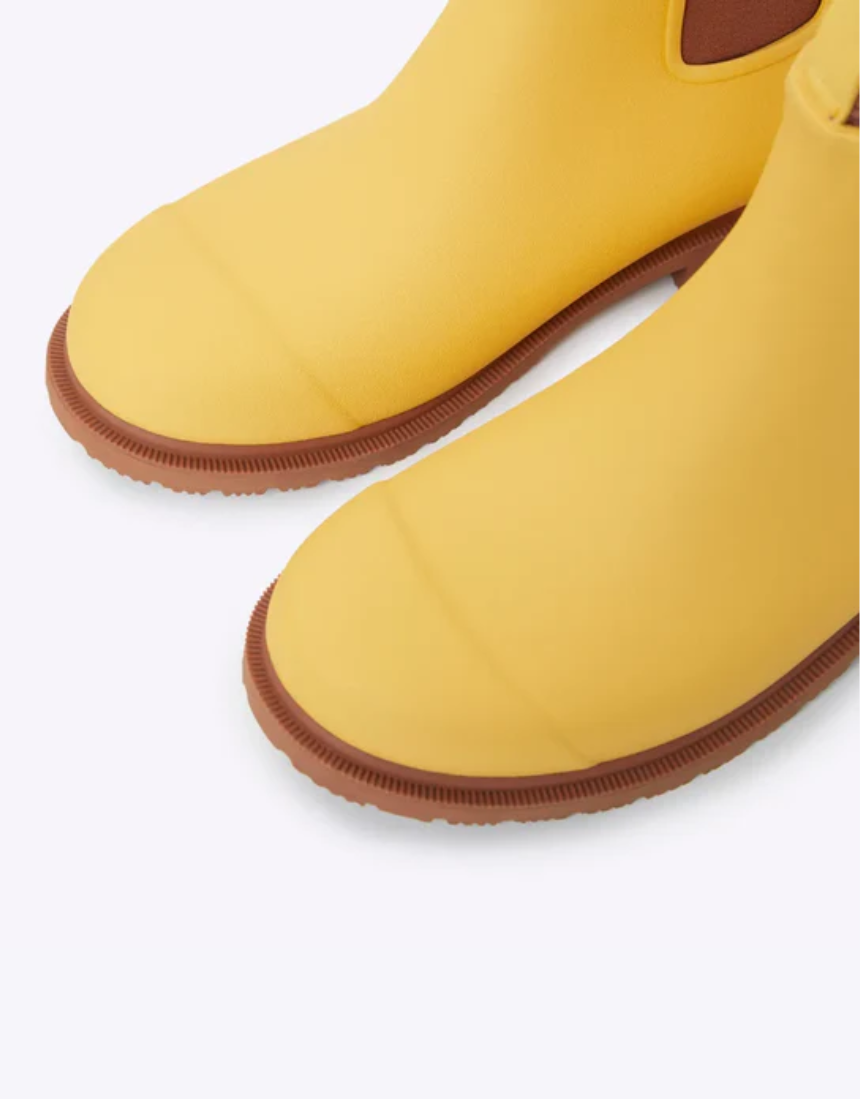 Yellow Merry People Bobbi gumboots with sunflower design, waterproof rubber boots for rainy days.