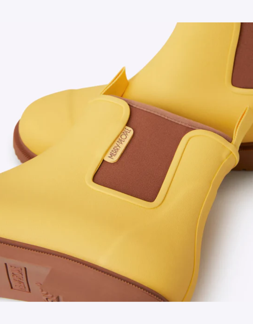 Yellow Merry People Bobbi gumboots with sunflower design, waterproof rubber rain boots for women, stylish and durable footwear