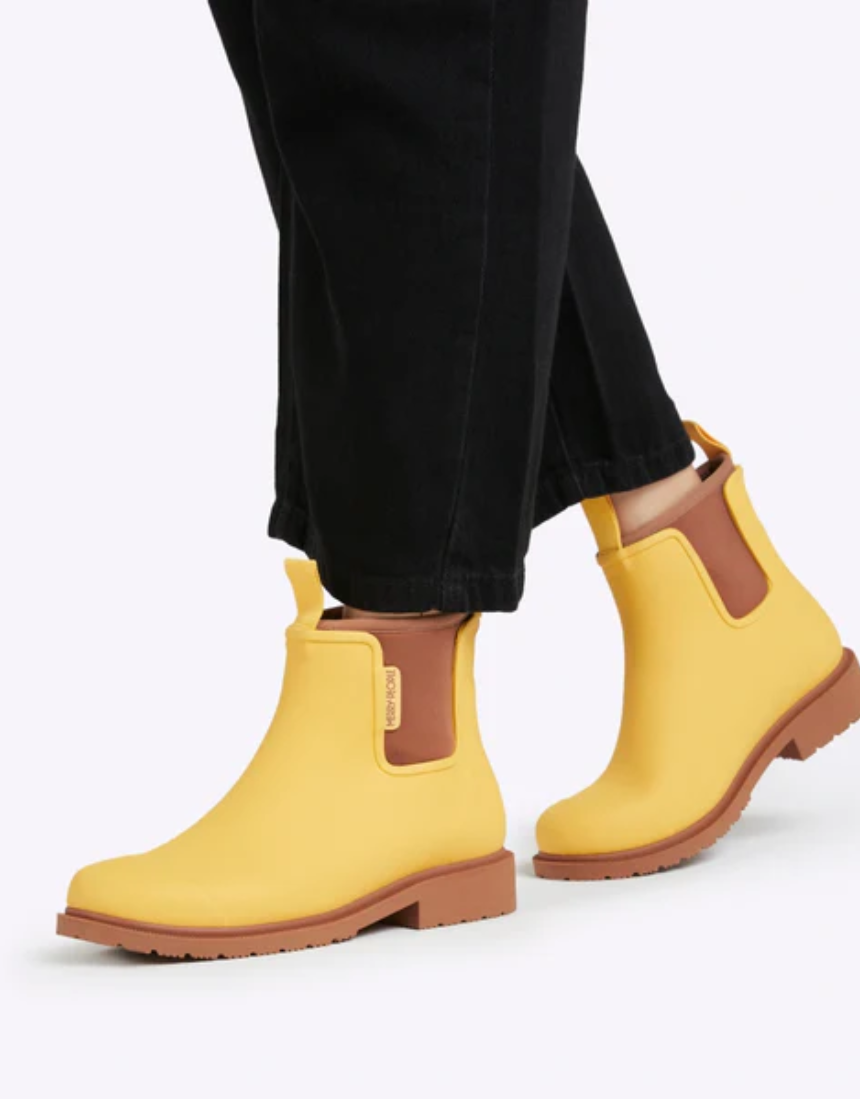 Bright sunflower yellow Merry People Bobbi gumboots with waterproof rubber, designed for rainy weather and outdoor activities.