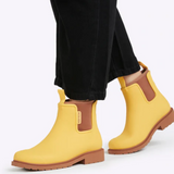 Bright sunflower yellow Merry People Bobbi gumboots with waterproof rubber, designed for rainy weather and outdoor activities.