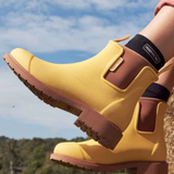 Yellow Merry People Bobbi gumboots with sunflower design, waterproof rain boots for women and outdoor wear.