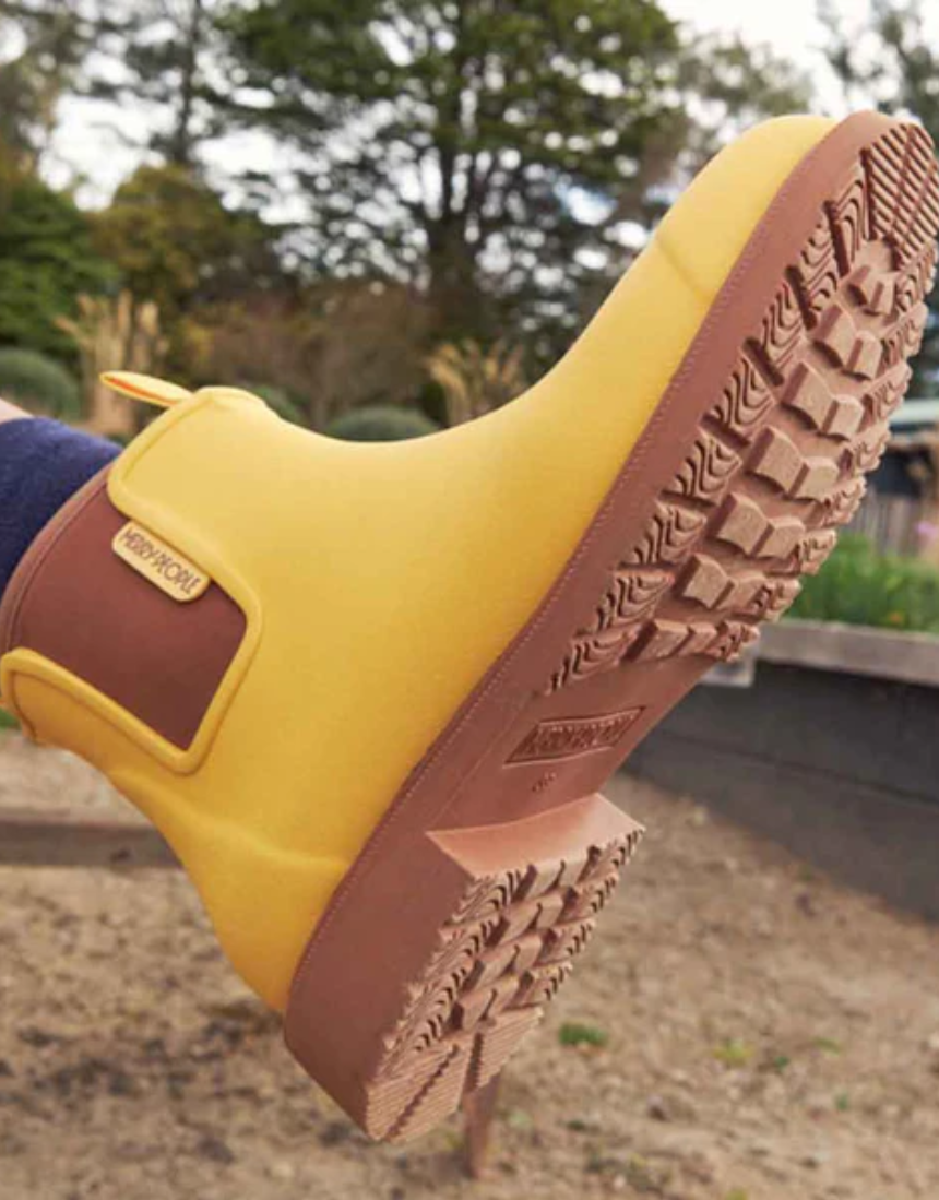 Yellow Merry People Bobbi gumboots with sunflower design, waterproof rain boots for women, stylish and durable footwear.