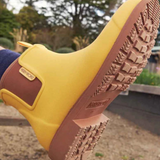 Yellow Merry People Bobbi gumboots with sunflower design, waterproof rain boots for women, stylish and durable footwear.