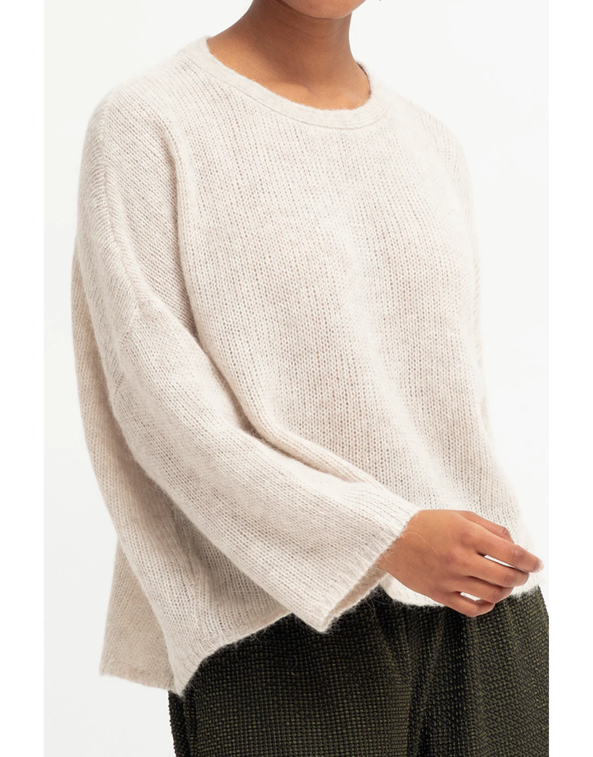Ecru Elk Agna Sweater jumper displayed on a hanger, showing its cozy knit fabric and classic design.