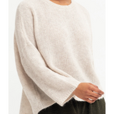 Ecru Elk Agna Sweater jumper displayed on a hanger, showing its cozy knit fabric and classic design.