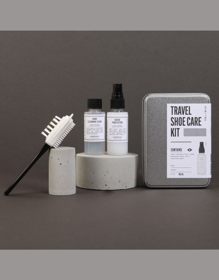Men's Society travel shoe care kit with brushes, polish, and accessories for men's shoe maintenance and cleaning.
