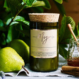 Mojo Candle Co. French Pear candle with a sleek jar and label, emitting a warm, inviting ambiance.