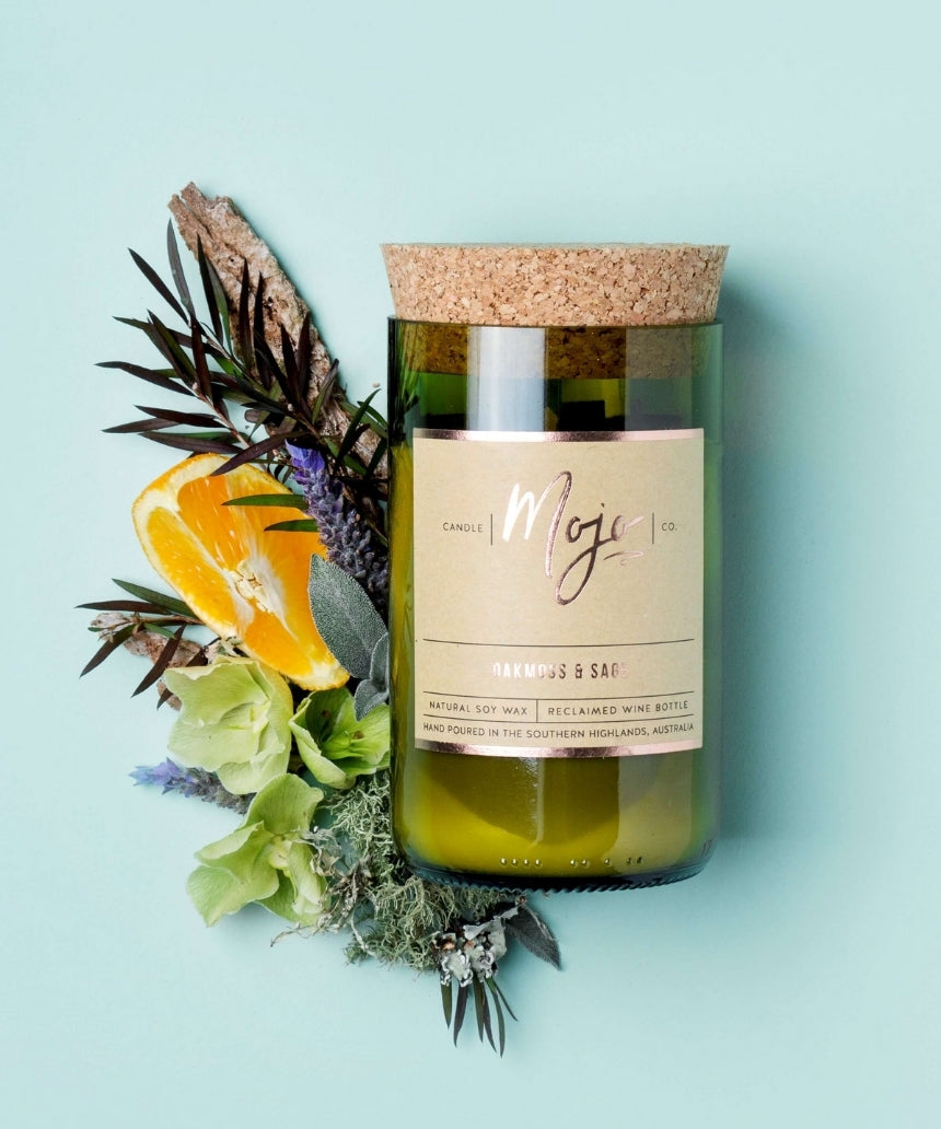 Mojo Candle Co. Oakmoss & Sage candle with a glass jar and natural wax, showcasing a calming scent and elegant design.