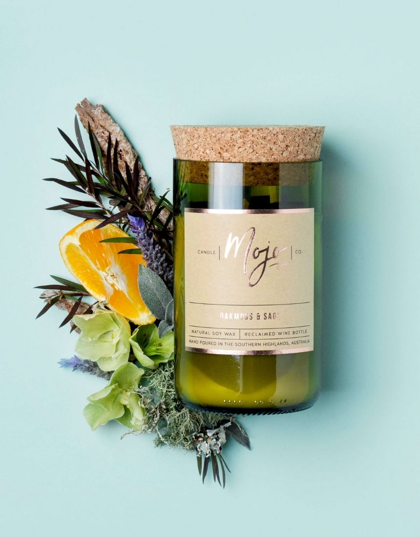 Mojo Candle Co. Oakmoss & Sage candle with a glass jar and natural wax, showcasing a calming scent and elegant design.