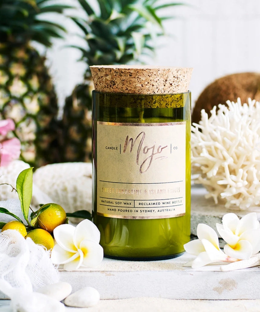Mojo Candle Co. sweet tangerine and island fruits scented candle with vibrant orange and tropical fruit design.