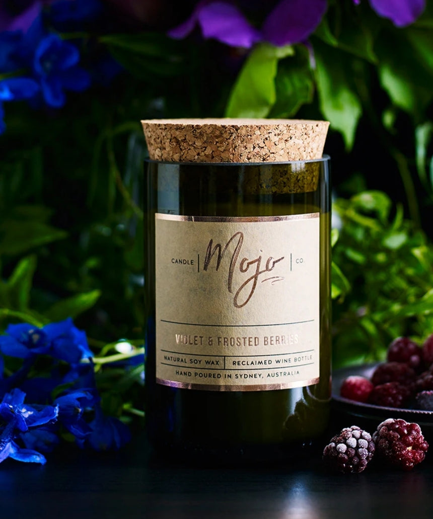 Violet and frosted berries scented candle by Mojo Candle Co. with a frosted glass holder and floral design.