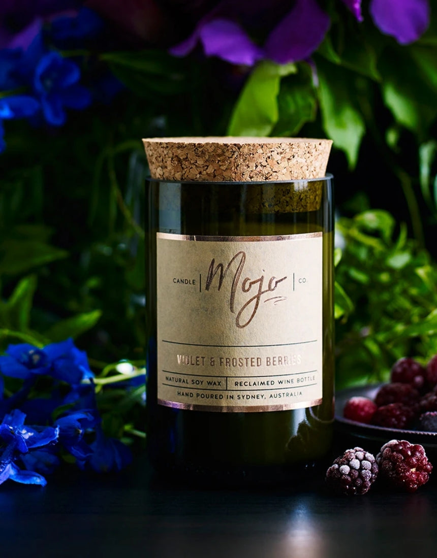 Violet and frosted berries scented candle by Mojo Candle Co. with a frosted glass holder and floral design.