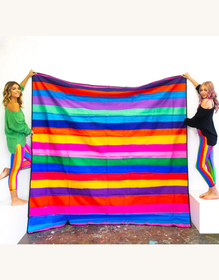 Riley Burnett picnic rug with colorful carnival stripe pattern, outdoor blanket for picnics and gatherings on grass or sand.