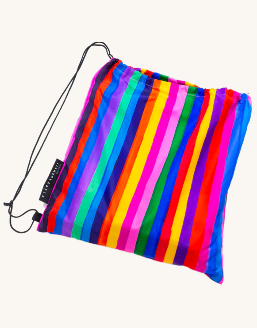 Riley Burnett carnival stripe picnic rug with colorful striped fabric, perfect for outdoor picnics and gatherings.