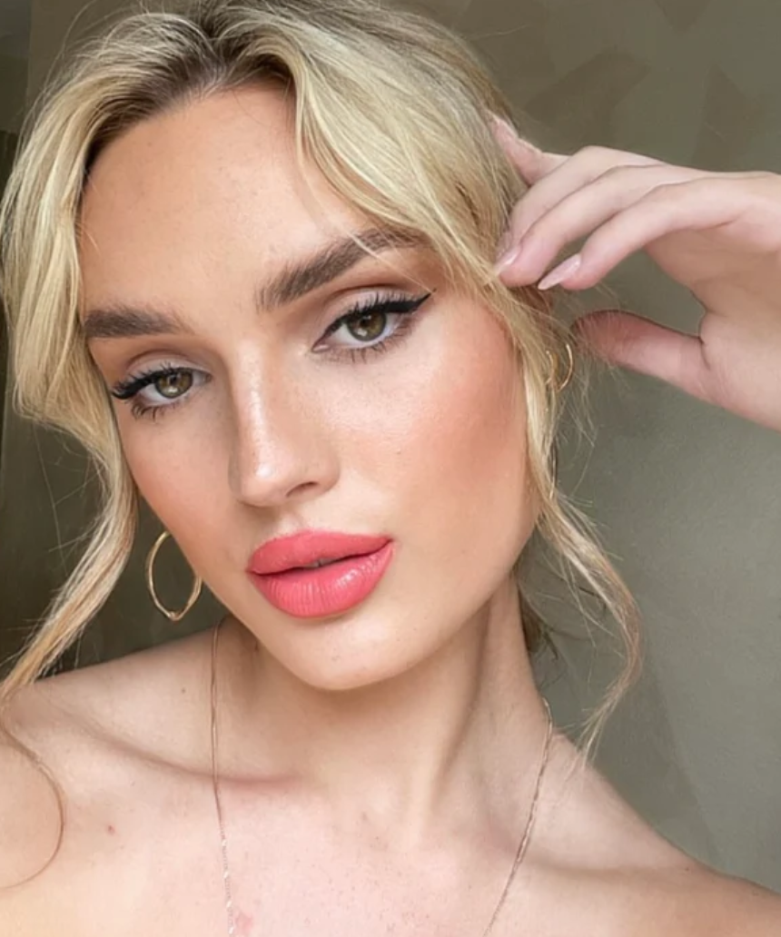 Suzy Lipsticks Grapefruit Matte lipstick, showcasing vibrant orange shade in sleek tube, close-up of the product.